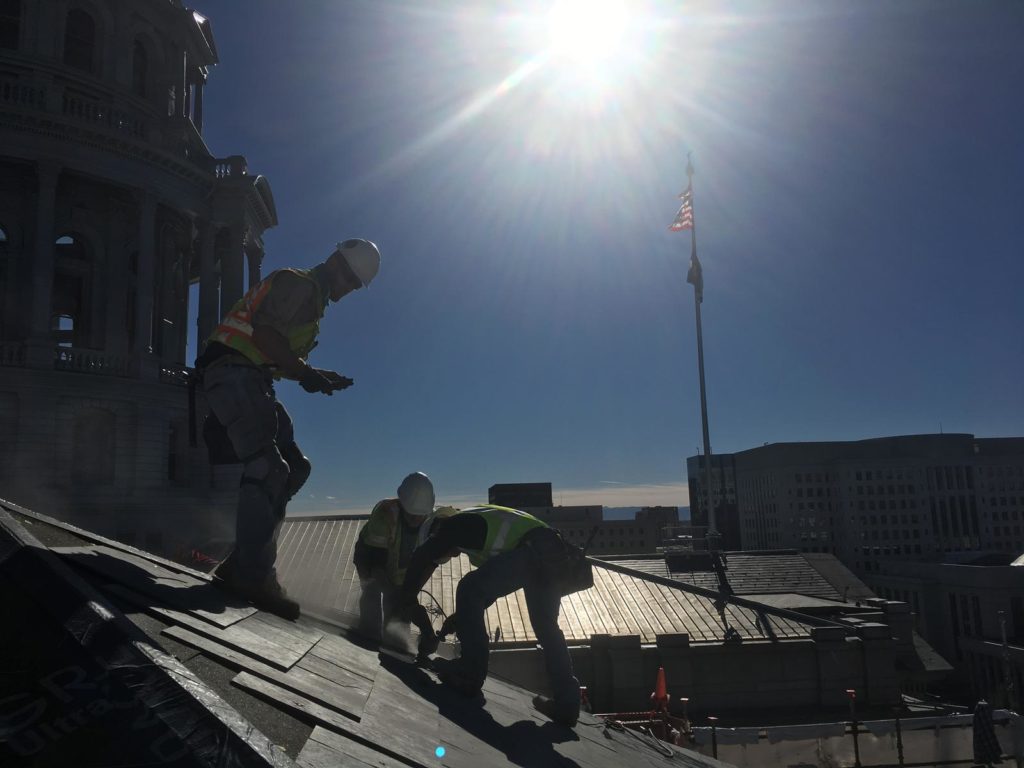Commercial Roofing project from Capitol Exterior, showing men working on the roof of the capitol building