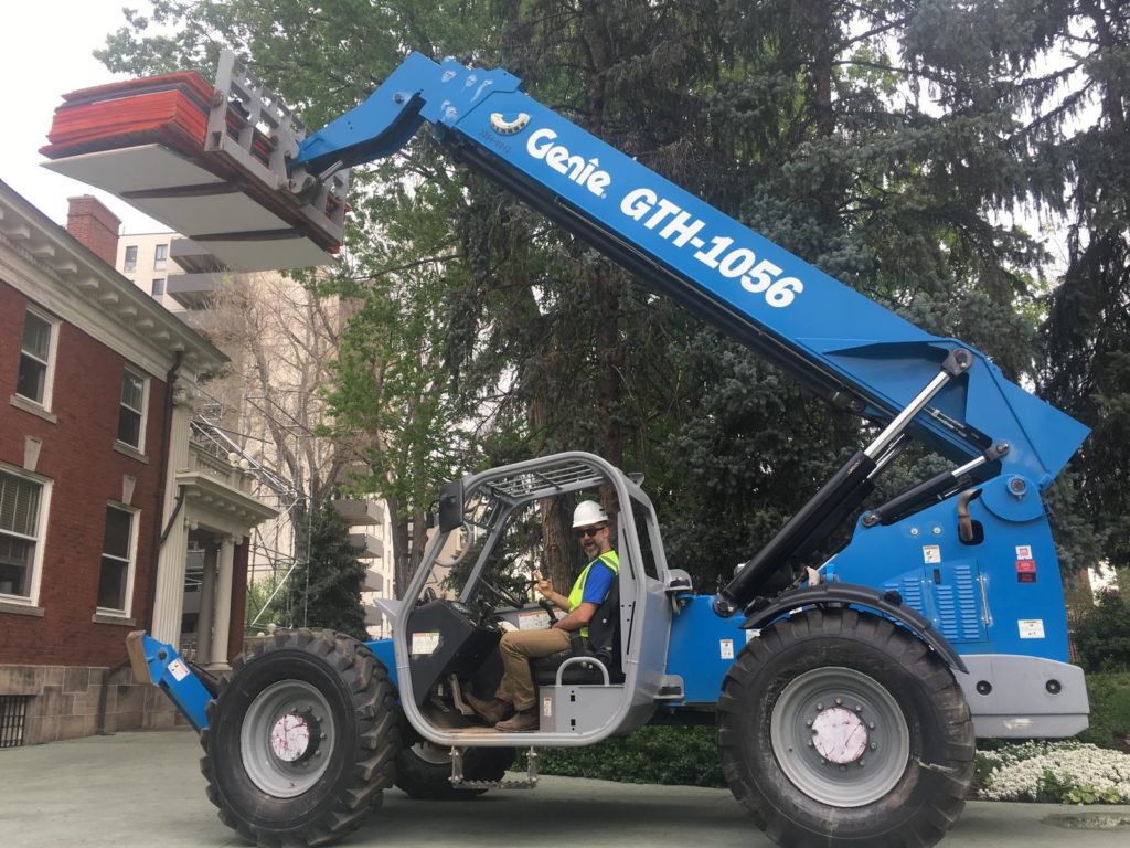 Man driving a Genie GTH-1056 forklift at Capitol Exterior Service